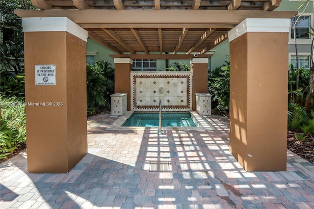 view of swimming pool with a community hot tub