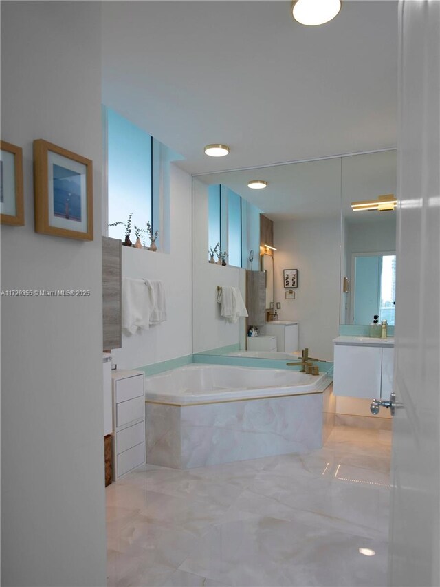 bathroom with vanity and a bath