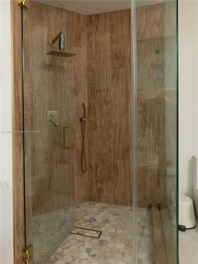 bathroom featuring a shower with shower door