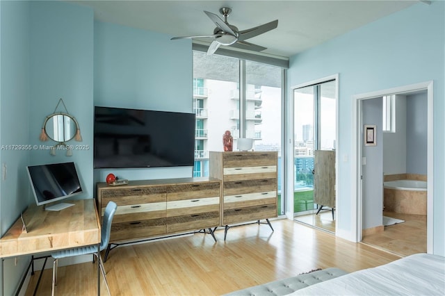 bedroom featuring light hardwood / wood-style floors and expansive windows