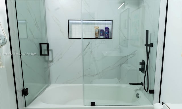 bathroom with shower / bath combination with glass door