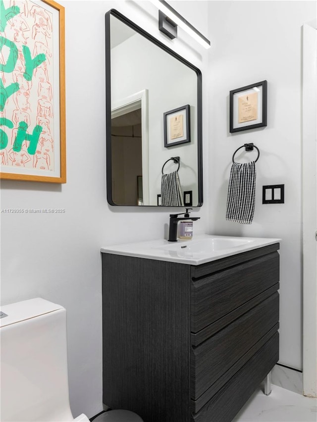 bathroom with toilet and vanity