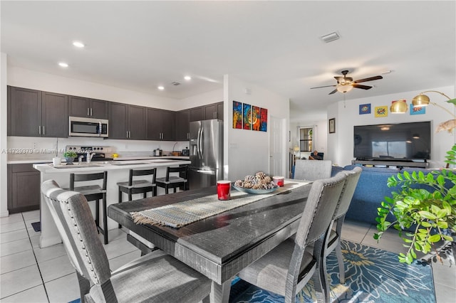 tiled dining area featuring ceiling fan