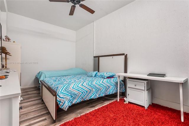 bedroom featuring ceiling fan and dark wood-type flooring