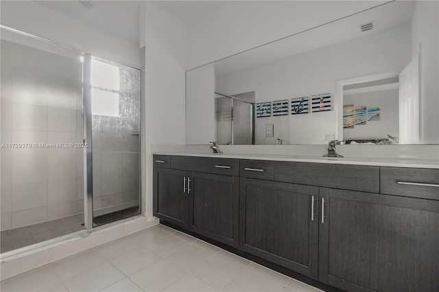 bathroom featuring tile patterned flooring, walk in shower, and vanity