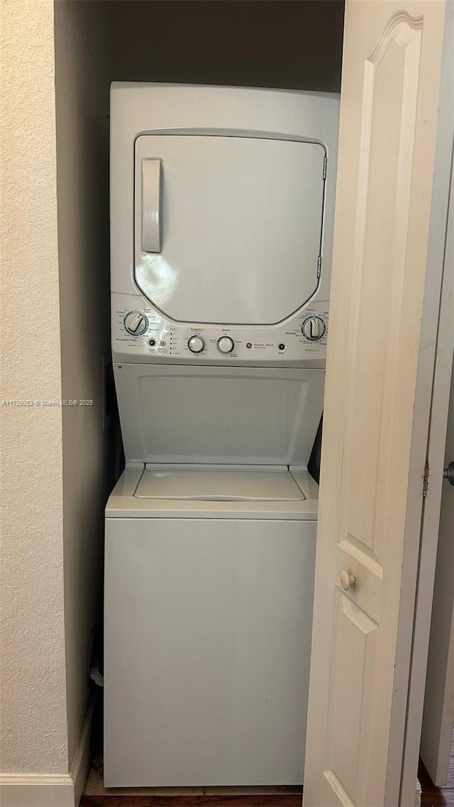 laundry room with stacked washer / dryer