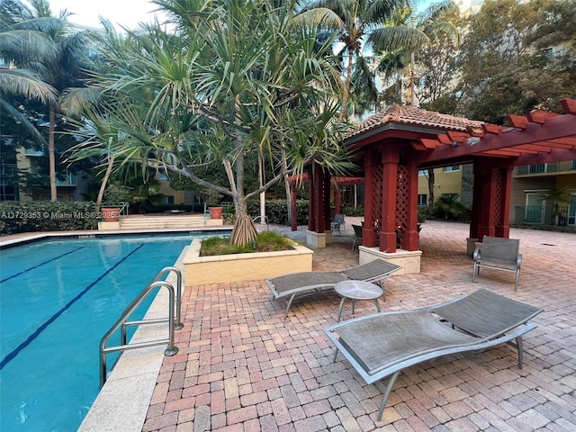 view of swimming pool with a pergola and a patio area