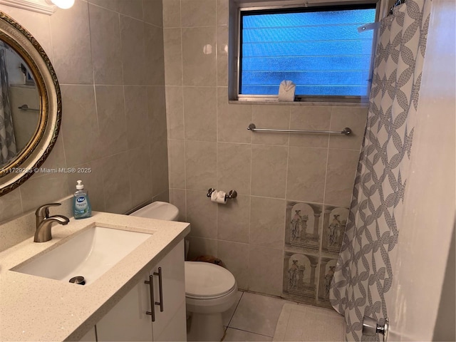 bathroom featuring tile patterned floors, tile walls, toilet, and vanity