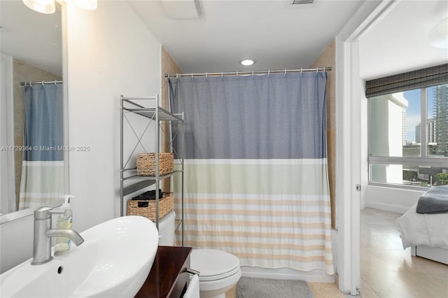 full bathroom featuring toilet, sink, and shower / bath combo with shower curtain