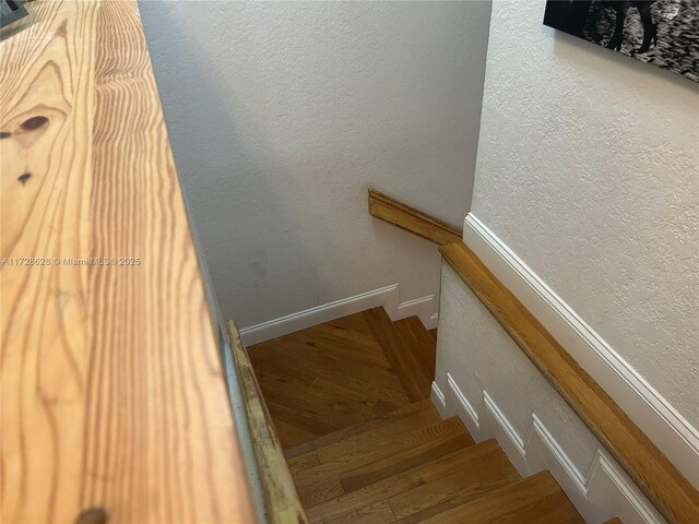 stairway featuring wood-type flooring