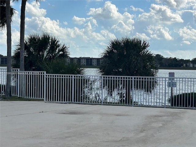 view of gate with a water view