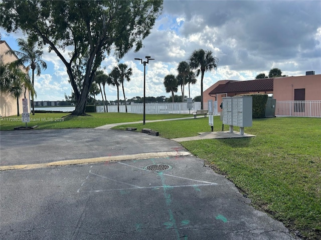 view of home's community with a yard and a mail area