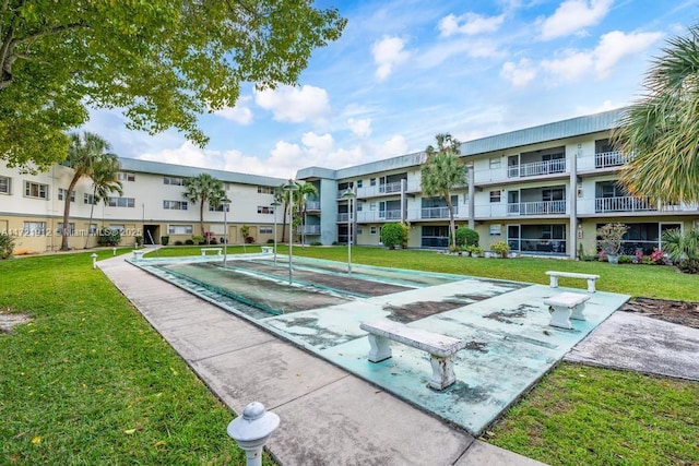 surrounding community with a lawn, a residential view, and shuffleboard