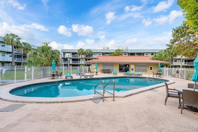 pool featuring a patio area and fence