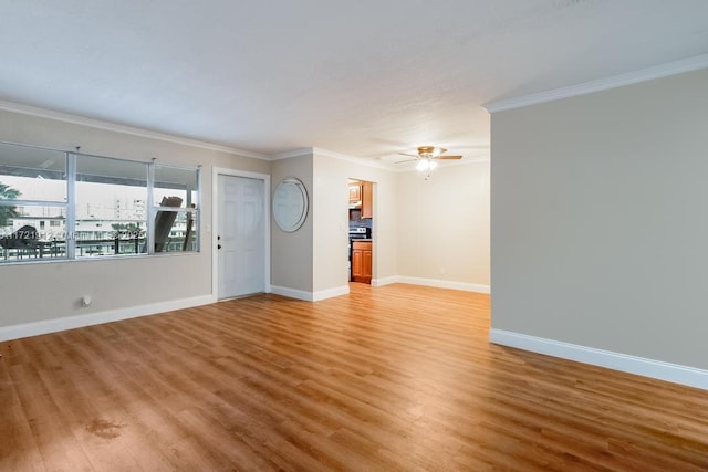 unfurnished living room with ornamental molding, wood-type flooring, and ceiling fan