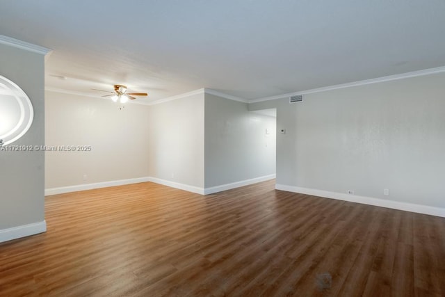 unfurnished room with ceiling fan, ornamental molding, baseboards, and visible vents