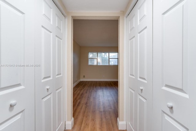 hall with light wood finished floors and baseboards