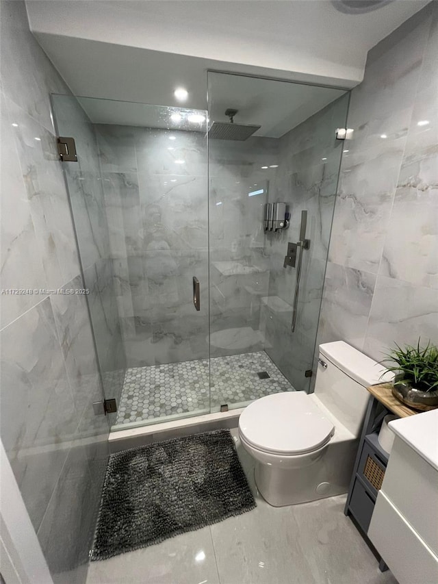 bathroom featuring toilet, tile walls, and a shower with door