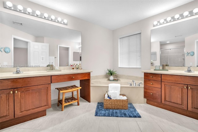 bathroom with vanity, tile patterned flooring, and shower with separate bathtub