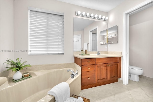 bathroom featuring tile patterned floors, toilet, vanity, and a bath