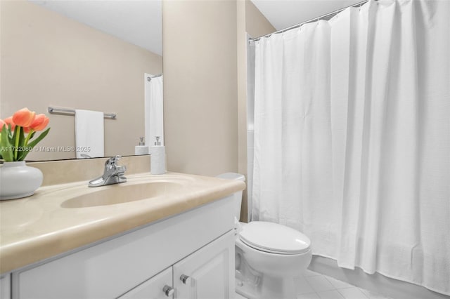 bathroom featuring toilet, vanity, a shower with curtain, and tile patterned flooring