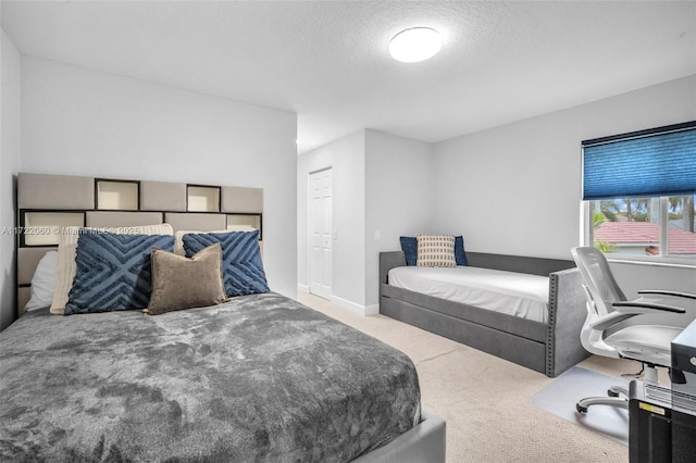 bedroom with a textured ceiling and carpet flooring