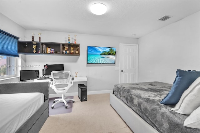 bedroom with a textured ceiling and carpet