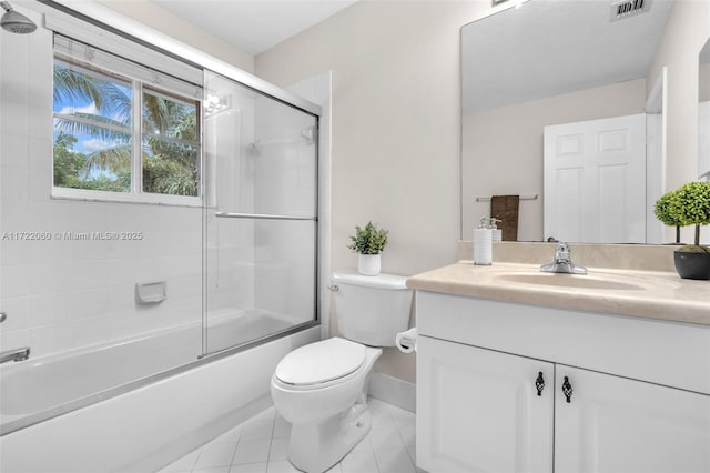 full bathroom with toilet, vanity, tile patterned flooring, and combined bath / shower with glass door