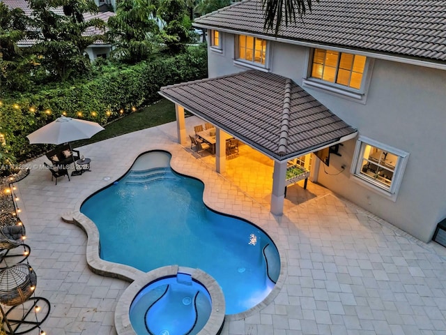 view of pool featuring an in ground hot tub, a patio area, and a gazebo