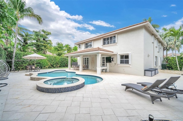 view of pool with a patio area and an in ground hot tub