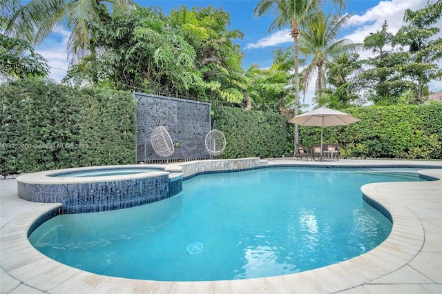 view of swimming pool featuring an in ground hot tub