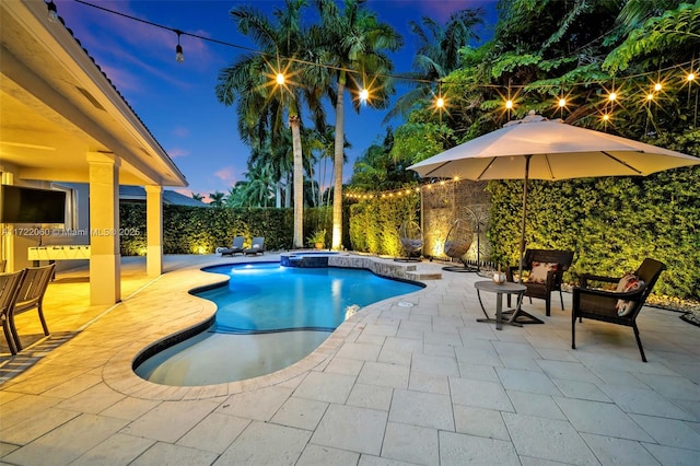 pool at dusk with a patio