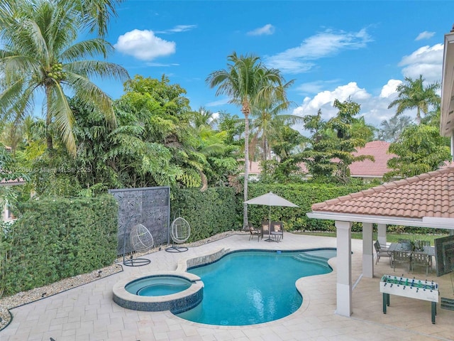 view of pool with a patio area, a gazebo, and an in ground hot tub