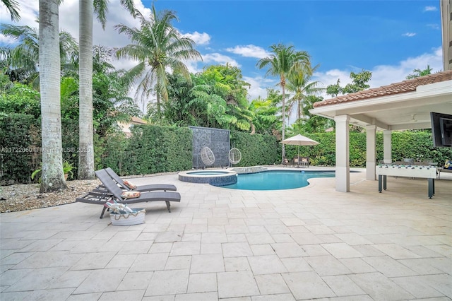 view of swimming pool featuring an in ground hot tub and a patio