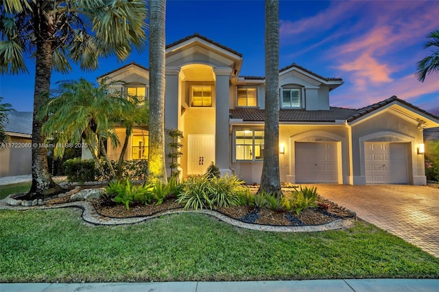 mediterranean / spanish house featuring a yard