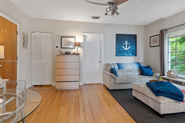 living room featuring ceiling fan and hardwood / wood-style flooring