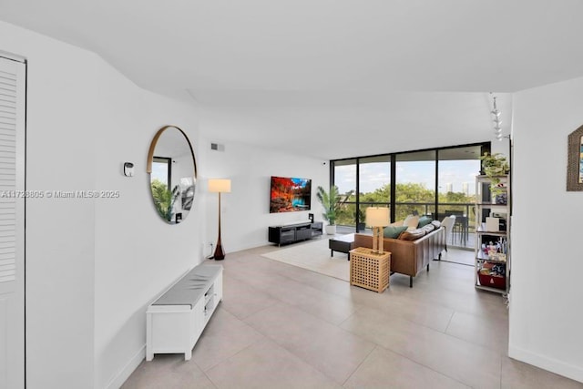 living room with track lighting and expansive windows