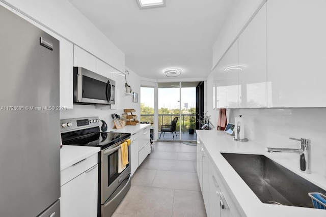 kitchen featuring sink, white cabinetry, and appliances with stainless steel finishes