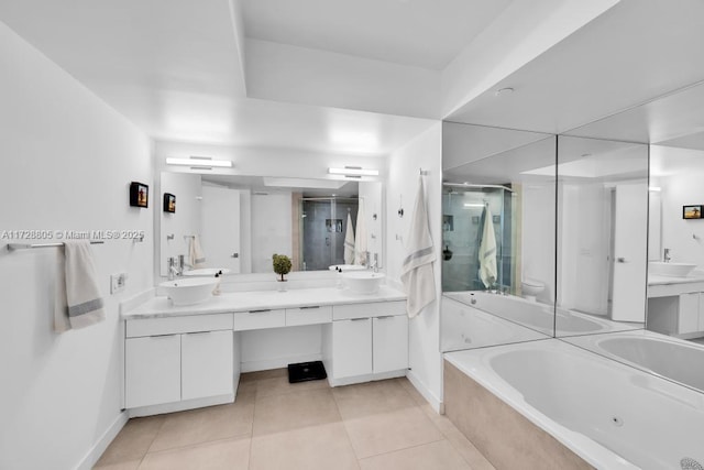 bathroom with independent shower and bath, tile patterned floors, and vanity