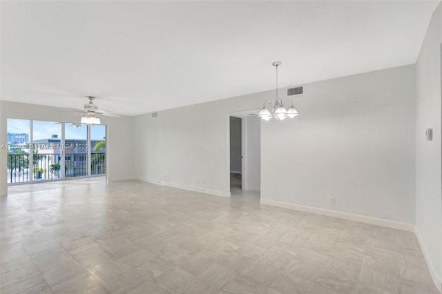 empty room with ceiling fan with notable chandelier