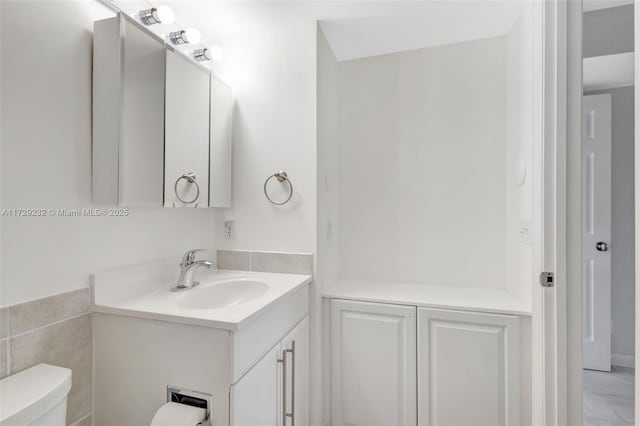 bathroom featuring toilet and vanity