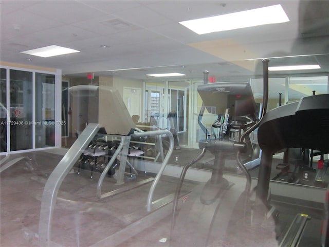 exercise room with a paneled ceiling