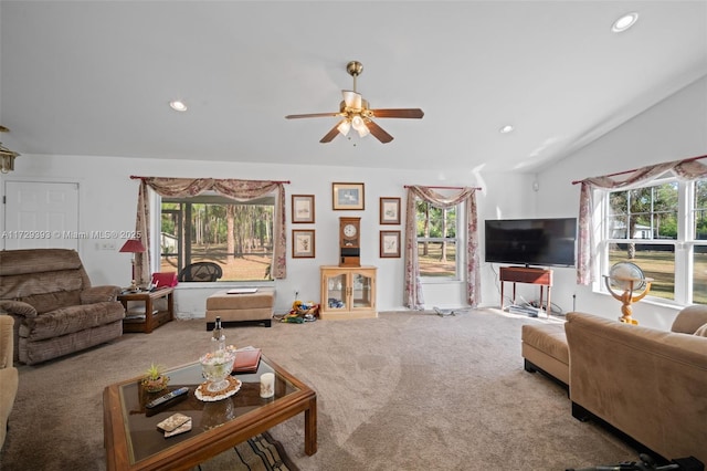 carpeted living room featuring ceiling fan and lofted ceiling