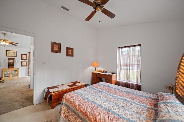 carpeted bedroom with ceiling fan and vaulted ceiling