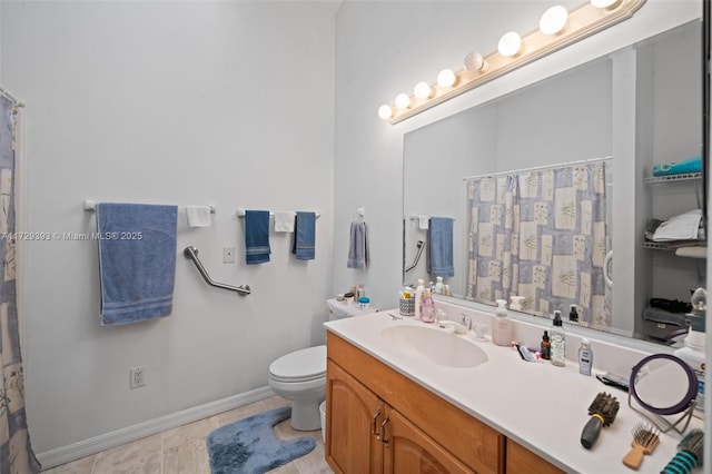 bathroom with toilet, vanity, and tile patterned floors