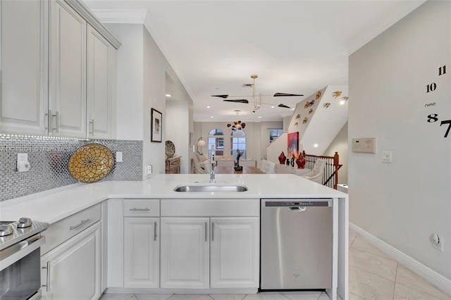 1033 NE 17th Way Unit 704, Fort Lauderdale, FL 33304 - kitchen featuring stainless steel appliances, a peninsula, ceiling fan, decorative backsplash, and light countertops