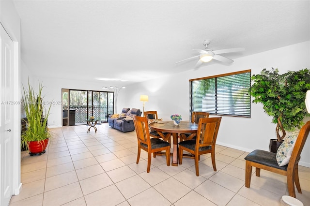 tiled dining space with ceiling fan