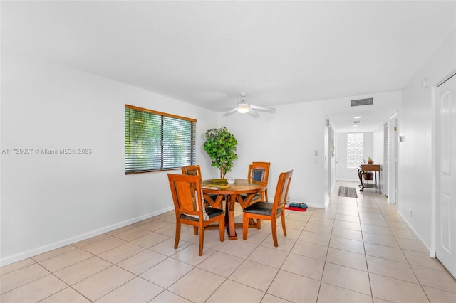 dining space featuring ceiling fan and light tile patterned floors