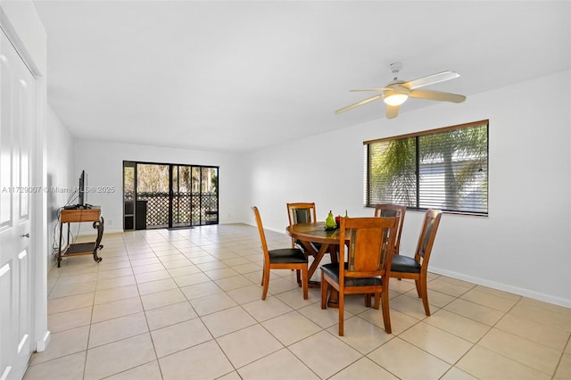 dining space featuring light tile patterned flooring and ceiling fan