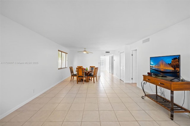 tiled dining space featuring ceiling fan